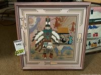 Frontal view of the framed 3D Native American themed artwork showing the figure with feathered headdress and turquoise necklace, decorative frame border.
