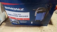 Box showing Simoniz brand, product image, and 1650 PSI rating for pressure washer model.