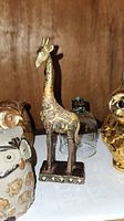 Jewelled giraffe figurine standing on rectangular base, around 7 inches tall, decorative gem-like details on body and legs