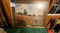 Front view of the framed print showing the Poppies scene by Claude Monet with glass reflection.