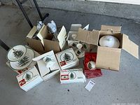 Overview of boxed Spode Christmas Tree dinnerware and accessories including cookie jar and stemware.