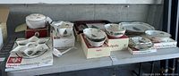 Wide view showing collection of Spode Christmas Tree pattern serveware including star-shaped hors d'oeuvre dish, bowls, trays, platters in original boxes