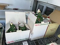 Multiple ceramic pieces in Spode Christmas Tree boxes showing teapot, creamer, and sugar bowl.