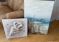 Both wall art pieces shown side-by-side with couch background for scale.