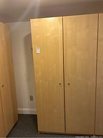 Closed wood wardrobe cabinet, showing overall appearance and door design.