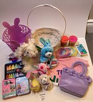 Full view of all Easter basket items including baskets, plush toys, T-shirt, Play-Doh, crayons, and other small toys organized on floor