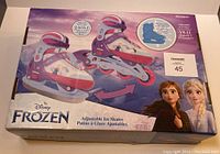 Box showing Disney Frozen branding and adjustable ice skates/roller blades with cartoon characters Anna and Elsa.