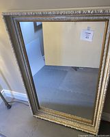 Full view of large rectangular mirror with thick white ornate frame and gold inner trim showing overall condition and size.