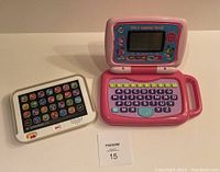 Photo of white Leap Frog Smart Stages tablet with colorful icon buttons on the screen and speaker holes below.