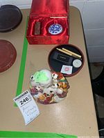 Colorful Asian porcelain figurine depicting a multi-faced mythical figure with green facial paint