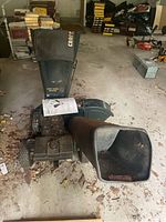 Full view of Craftsman chipper shredder with drop-down hopper showing dirt and evidence of rodents on the floor around it, located in a garage.