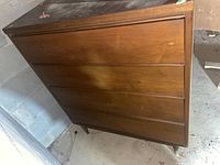 Full front view of the dresser showing four drawers and overall wood finish.