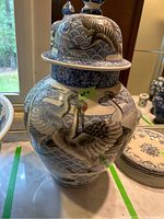 Front and side view showing detailed crane artwork on body and approximate size.