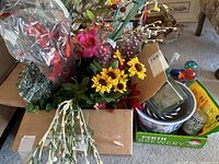 Full view of box with faux floral stems, flower pots, scissors, watering bulbs, and more