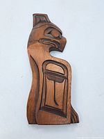 Front of the carved wooden First Nations Thunderbird panel showing detailed stylized carving.