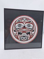 Front view of the framed limited edition print featuring a stylized beaver design, black frame and glass.