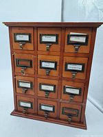 Front view of wooden organizer, all 12 drawers closed