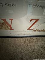 Close-up view of bottom section of the print showing letters Y and Z along with Anne Geddes signature plate on the frame.