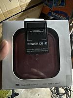 Photo of MPOW Power Cube mini cubic power bank inside retail packaging showing brand and product details