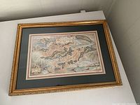 Framed lithograph artwork showing the full piece in its decorative gold frame with double mat.