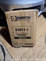 Front view of the cardboard box showing the brand, model number B3011-1, and item description 'Shower Bench With Arms and Back.'