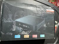 Box of TV Box showing front packaging with product features like CPU 64 Bit, H.265, CPU 4 Core, 4K UHD