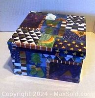 Colorful Christmas storage box with patchwork holiday designs shown closed