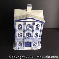 Front view showing detailed facade of ceramic house cookie jar with bank sign and chimney lid.