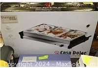 Photo of the boxed Casa Dolce stainless steel triple buffet server showing brand and product image on packaging.