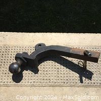 Black metal auto hitch with ball mount, square end, pin included, displayed on outdoor surface