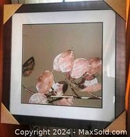 Full view of the framed floral print with corner protectors.