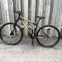 Side view of men's Fallout Wicked ASR DX 9500 bicycle showing black frame with colored graphics and 29-inch wheels.