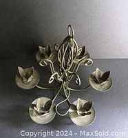 Top-down view showing the 6 petal-shaped candle holders and the curled metal arms of the candle holder chandelier.