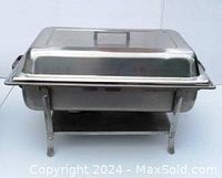 Closed rectangular stainless steel chafing set showing lid and rack with four legs