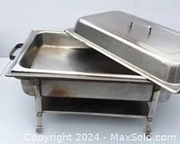 Photo showing the rectangular chafing set with lid lifted, displaying the food pan and water pan inside.