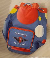 Front and top view of colorful British Airways Skyflyers mini backpack with drawstring closure, showing circular retro pattern and zippered pouch with embroidered logo.