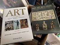 Two hardcover art books in a box: 'Art: A History of Painting, Sculpture, Architecture' by Frederick Hartt and 'Art at Auction The Year at Sotheby Parke Bernet 1977-78' with sculpture imagery.