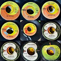Close-up photos of multiple Beatles 45 RPM record labels including 'Strawberry Fields Forever', 'Yesterday', and others.