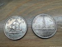 Obverse and reverse images of two Canadian silver dollar coins from 1939 and 1949 showing both sides with details visible.