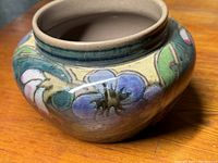 Close-up angled photo of the rounded Gouda vase showing detailed hand-painted floral pattern and glossy finish.