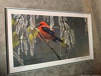Front view of the Robert Bateman print featuring a red cardinal on a branch, showing the pencil signature and edition number (1142/1500) below the image and the artist's signature on the bottom right.