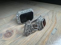 View of all three rings together, showing black onyx ring, amber stone ring, and smallest marcasite band ring.
