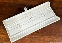 Delicate white gold chain necklace laid in white satin-lined hinged jewelry box