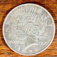 Obverse side of the 1923 S Silver Peace Dollar coin showing Liberty head and inscriptions.