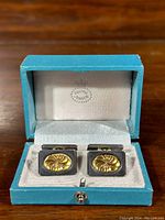 Open turquoise Georg Jensen box with cufflinks installed