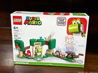 Photo of front of the branded Lego box showing set 71406 Yoshi's Gift House with 246 pieces for ages 6+. Shows Lego and Super Mario branding and expansion set label.