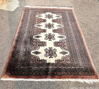 Full view of rug laid flat showing entire pattern and border