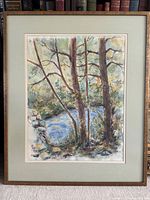 Framed original watercolor painting with pen and ink details showing three trees by a river, in muted natural colors, with a pale green mat and simple wood frame.