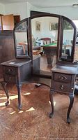 Full view of the Krug Bros. swing mirror bedroom vanity with the three-part mirrored top and two drawer compartments on each side showing original finish and wood grain.