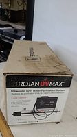 Box for Trojan UV MAX Ultraviolet (UV) Water Purification System model C4 with branding and warranty information visible